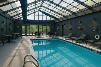 A swimming pool inside a room with a glass ceiling.
